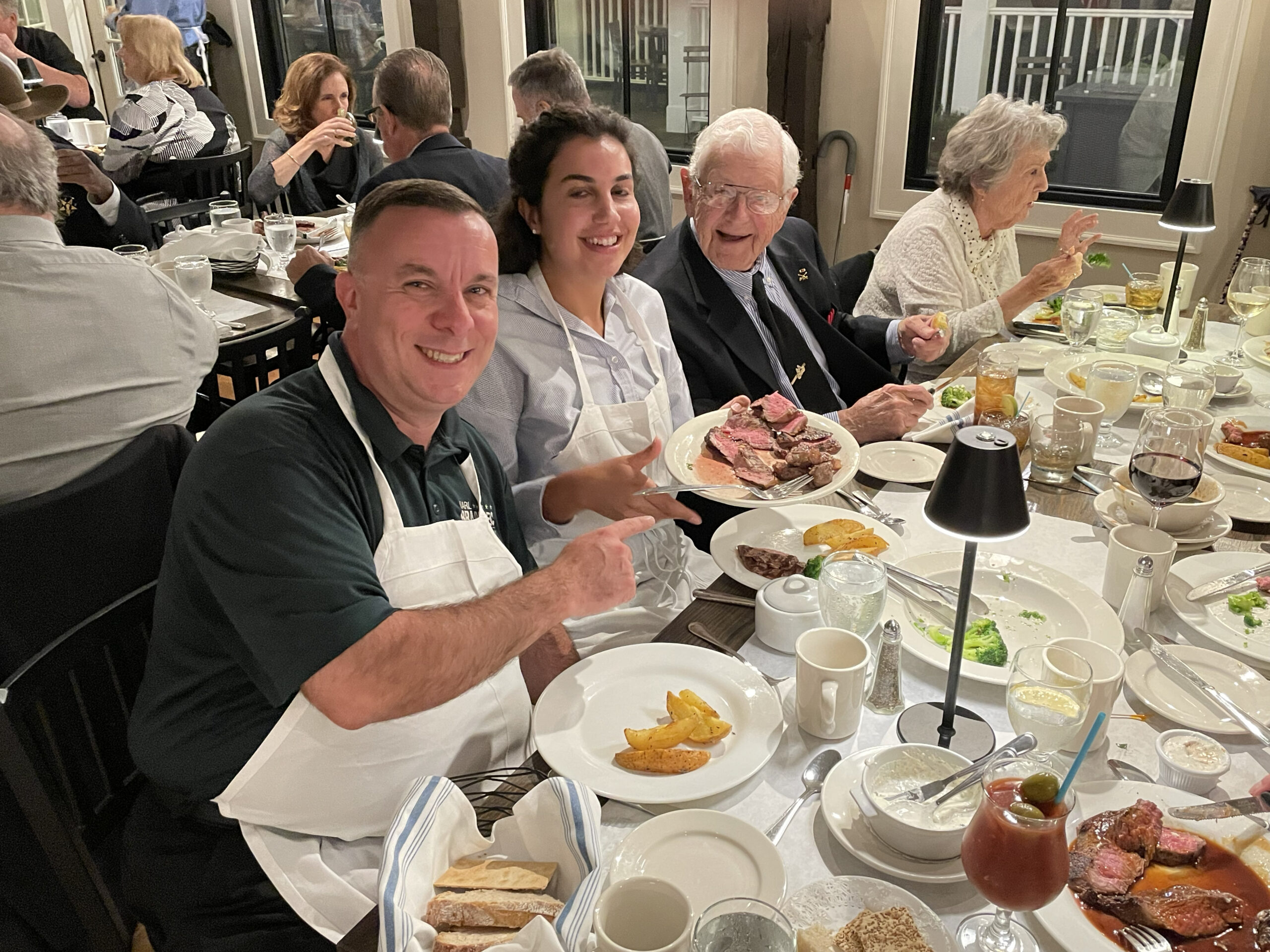 Seated diners: Karl Brabanec and Yasmine Boiuachri serve dinner to guests at the Rushock Veterans Foundation dinner
