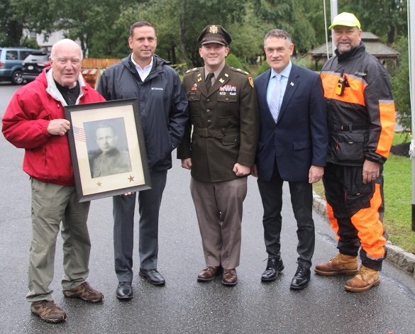 (From left to right) Andrew Komonchak of Bloomingburg, Orange County Executive Steven M. Neuhaus, Major Jacob Morris, Veterans Service Agency Director Christian Farrell and Dave Andryshak, Superintendent of the VSA Cemetery. Komonchak is holding a portrait of Russell Miller of Bullville, a member of the 107th Regiment who died during World War I