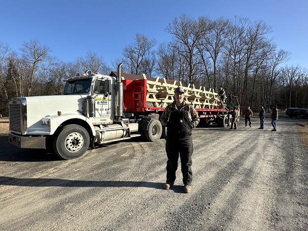 Travis Coleman in front of the load of tables he donated